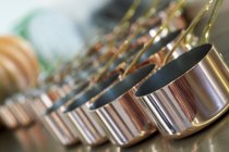 Closeup view of copper pans in rows — Stock Photo