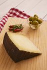 Wedge of Manchego and bowl — Stock Photo
