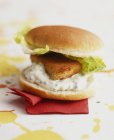 Fish burger with sauce — Stock Photo