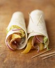 Closeup view of wraps filled with smoked turkey breast and oranges — Stock Photo