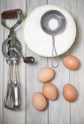 Rotary hand whisk with eggs and sugar — Stock Photo