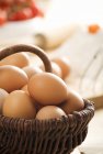 Fresh eggs in a willow basket — Stock Photo