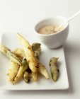 Deep-fried asparagus with sauce — Stock Photo