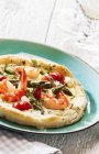 A prawn tart with green asparagus on green plate — Stock Photo