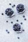 Blueberries in bowls on tablecloth — Stock Photo
