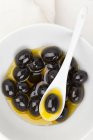 Black olives in olive oil — Stock Photo