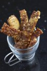 Closeup view of crispy pork cracklings in glass cup — Stock Photo
