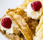 Waffles with raspberry and cream — Stock Photo
