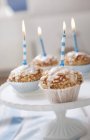 Muffins with birthday candles — Stock Photo
