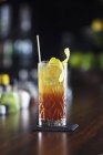 Cocktail with lemon peel — Stock Photo