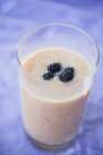 Peach milkshake with blackberries — Stock Photo