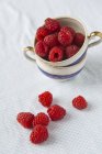 Fresh Raspberries in vintage cups — Stock Photo