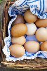 Brown chicken eggs in basket — Stock Photo