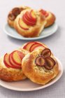 Sweet buns with plums — Stock Photo