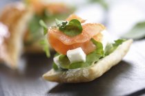 Small puff pastry with salmon — Stock Photo