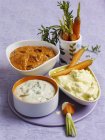 Carrots with assorted dips — Stock Photo