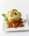 Olive muffin on tomatoes with basil — Stock Photo