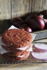 Stack of raw burgers — Stock Photo