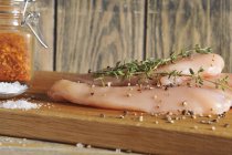 Raw chicken breast with spices and rosemary — Stock Photo