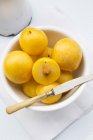 Yellow plums in bowl — Stock Photo