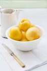 Yellow plums in white bowl — Stock Photo