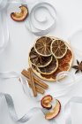 Top view of dried fruit with cinnamon sticks and ribbons — Stock Photo