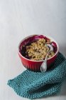 Closeup view of berry crumble with spoon in bowl — Stock Photo