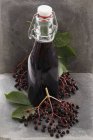 Bottle of elderberry juice — Stock Photo