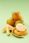 Whole and peeled mandarins — Stock Photo