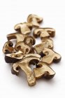 Closeup view of dried bay boletes on white surface — Stock Photo