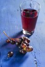 Red wine grapes and juice — Stock Photo