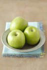 Green apples in plate — Stock Photo