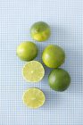 Fresh limes with halves — Stock Photo