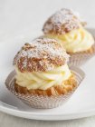 Mini cream puffs on table — Stock Photo