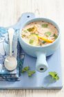 Closeup view of chicken and lemon soup with coriander leaves — Stock Photo