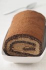 Roll dusted with cocoa powder — Stock Photo