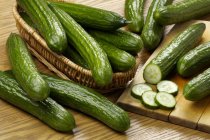 Fresh cucumbers with basket — Stock Photo