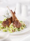 Lamb chops on couscous serving — Stock Photo