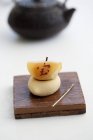 Closeup view of Wagashi with the Japanese symbol for treasure, luck and money on wooden board — Stock Photo