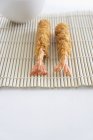 Tempura prawns on mat — Stock Photo
