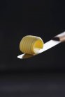 Closeup view of a curl of butter on a knife blade — Stock Photo