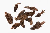 Closeup view of dried morels on white background — Stock Photo