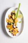 Kaki-Salat mit Preiselbeeren und Sellerie — Stockfoto
