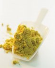 Mustard powder on a plastic scoop — Stock Photo