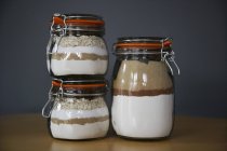 Closeup view of chocolate chip cookie and oatmeal raisin cookie mixes in preserving jars — Stock Photo