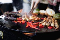 Spare ribs, sausages and vegetables on the barbeque — Stock Photo