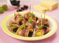 Prunes with cheese in bacon — Stock Photo