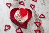 Pink cupcake with hearts — Stock Photo