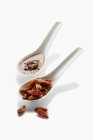 Two spoons with dried chillies and chilli oil on white background — Stock Photo