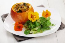 Fried Chantarelles in pumpkin with salad — Stock Photo
